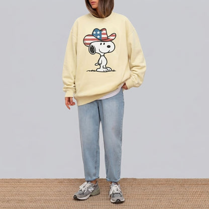 Person wearing a ivory sweatshirt with a cartoon character design on a plain background