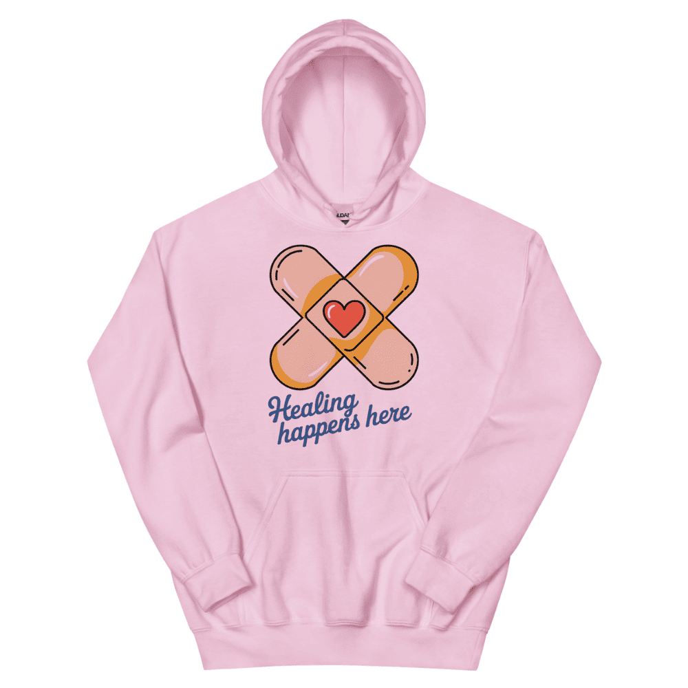Pink hoodie with bandage design and 'Healing happens here' text on a white background