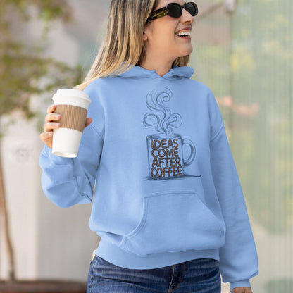 Person wearing a light blue hoodie with a coffee-themed design, holding a coffee cup.
