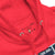 Close-up of a red hoodie with a label on a white background