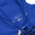 Close-up of a blue hoodie with text and labels on a white background