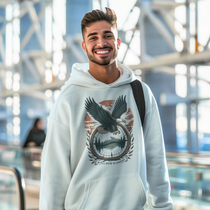 Man wearing a hoodie with an eagle design in an indoor setting