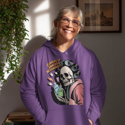 Person wearing a purple hoodie with a skeleton design and text, standing indoors.