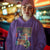 Person wearing a purple hoodie with a colorful graphic design in a casual setting.