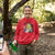 Person wearing a red hoodie with a cartoon character in a forest setting