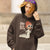 Person wearing a hoodie with a graphic design and text