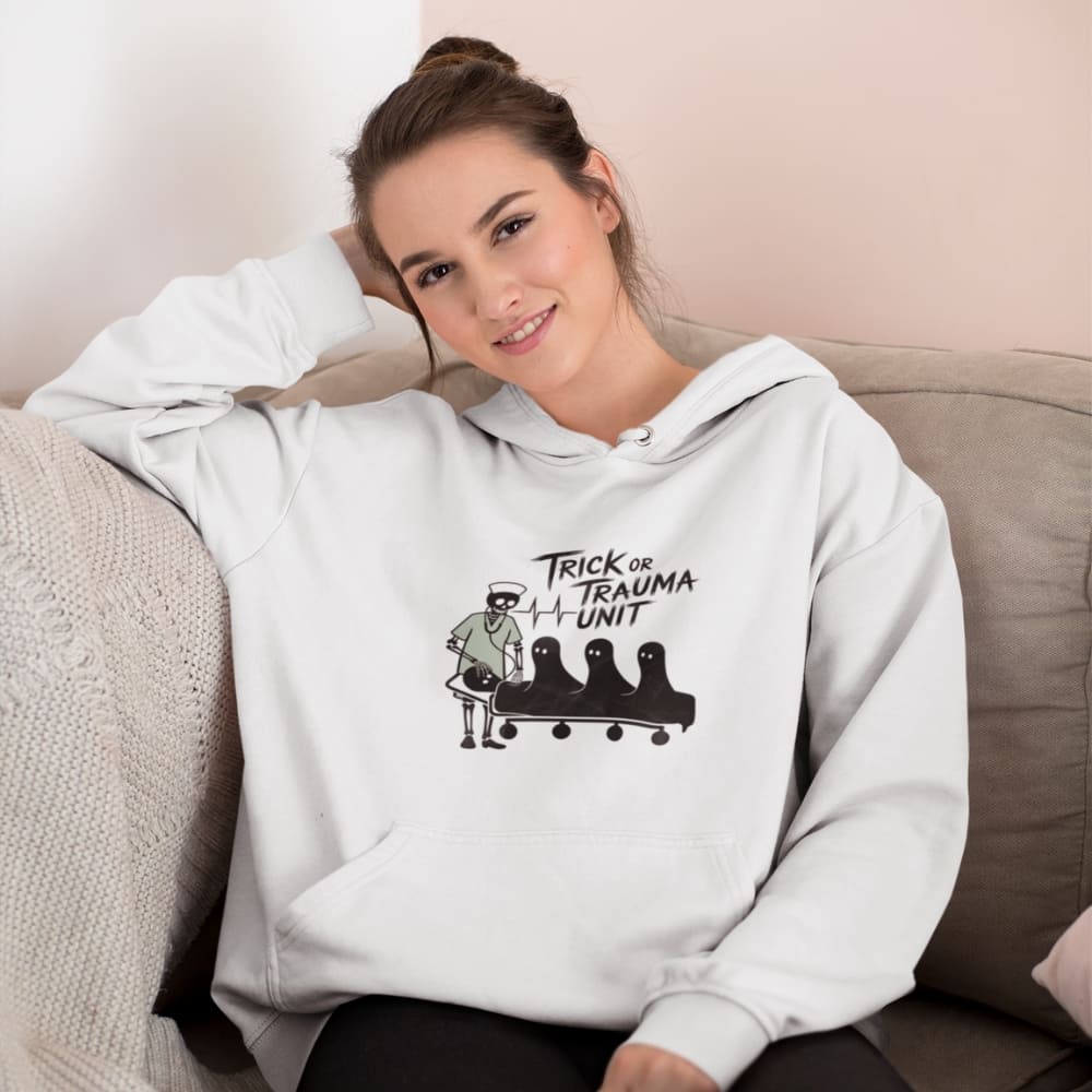 Woman wearing a white hoodie with a graphic design sitting on a couch.