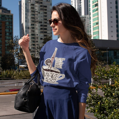 Woman wearing a blue sweatshirt with a coffee graphic in an urban setting