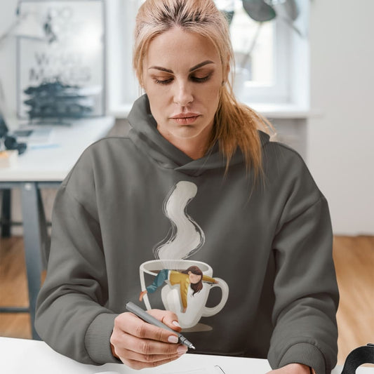 Person wearing a hoodie with a steamboat design, sitting at a table.