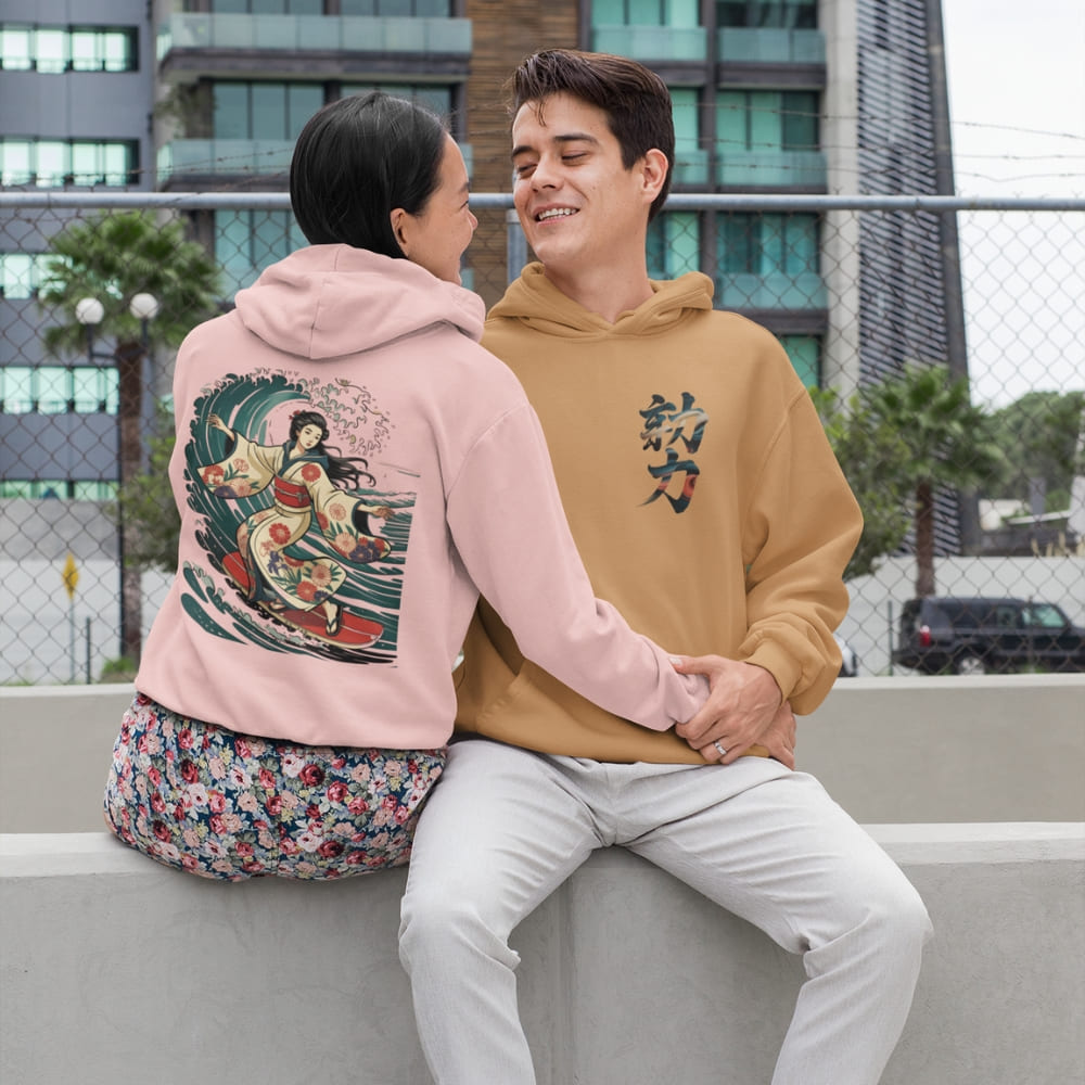 Two people sitting together wearing colorful hoodies with unique designs.