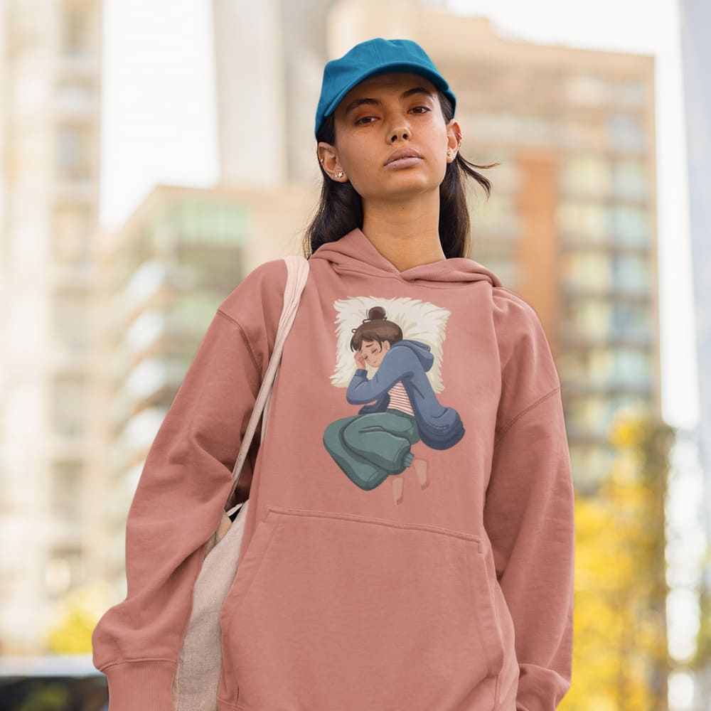 Person wearing a pink hoodie with a graphic design, standing outdoors with a blurred background