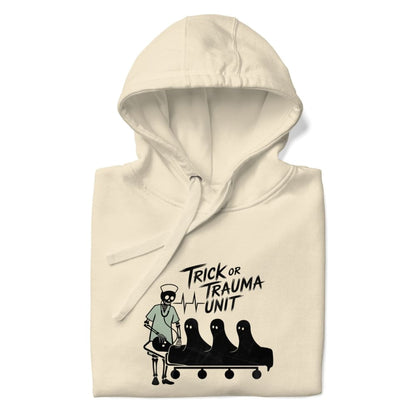 Beige hoodie with 'Trick or Trauma Unit' graphic design on a white background