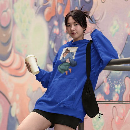 Person wearing a blue hoodie with a graphic design, holding a cup, and standing against a colorful mural.
