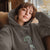 Person wearing a hoodie with a graphic design and text