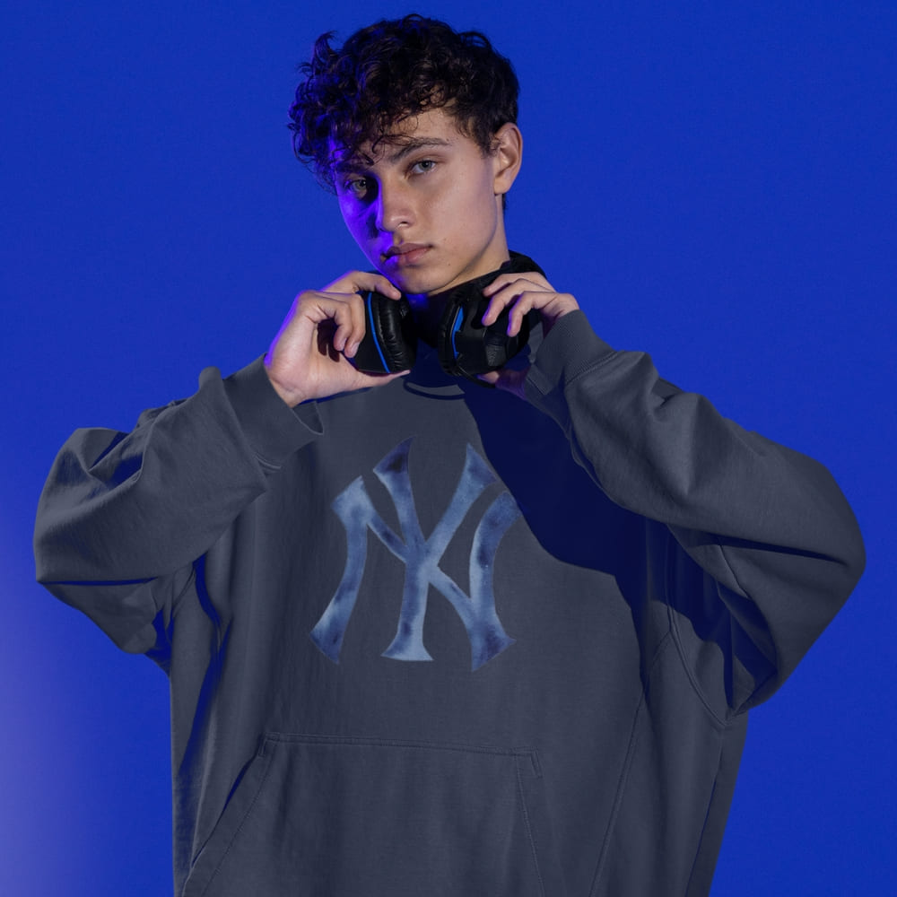 Person wearing a gray hoodie with a logo on a blue background