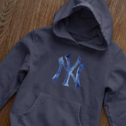 Navy blue hoodie with blue logo on a wooden surface