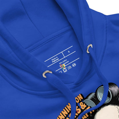 Close-up of a blue hoodie with a label and part of a graphic design visible.