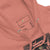Close-up of a pink hoodie with a label and spider-Man design on a white background