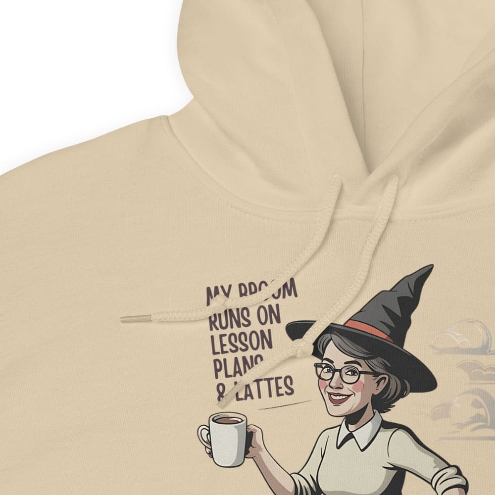 Beige hoodie with a graphic of a witch holding a coffee cup and text on a white background