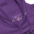 Close-up of a purple hoodie with a label on the chest area.