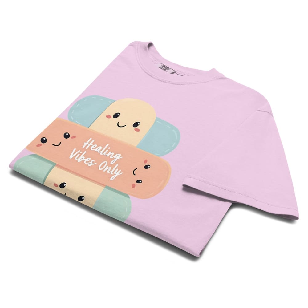 Pink sweatshirt with cartoon candy design and 'Healing Vibes Only' text on a white background