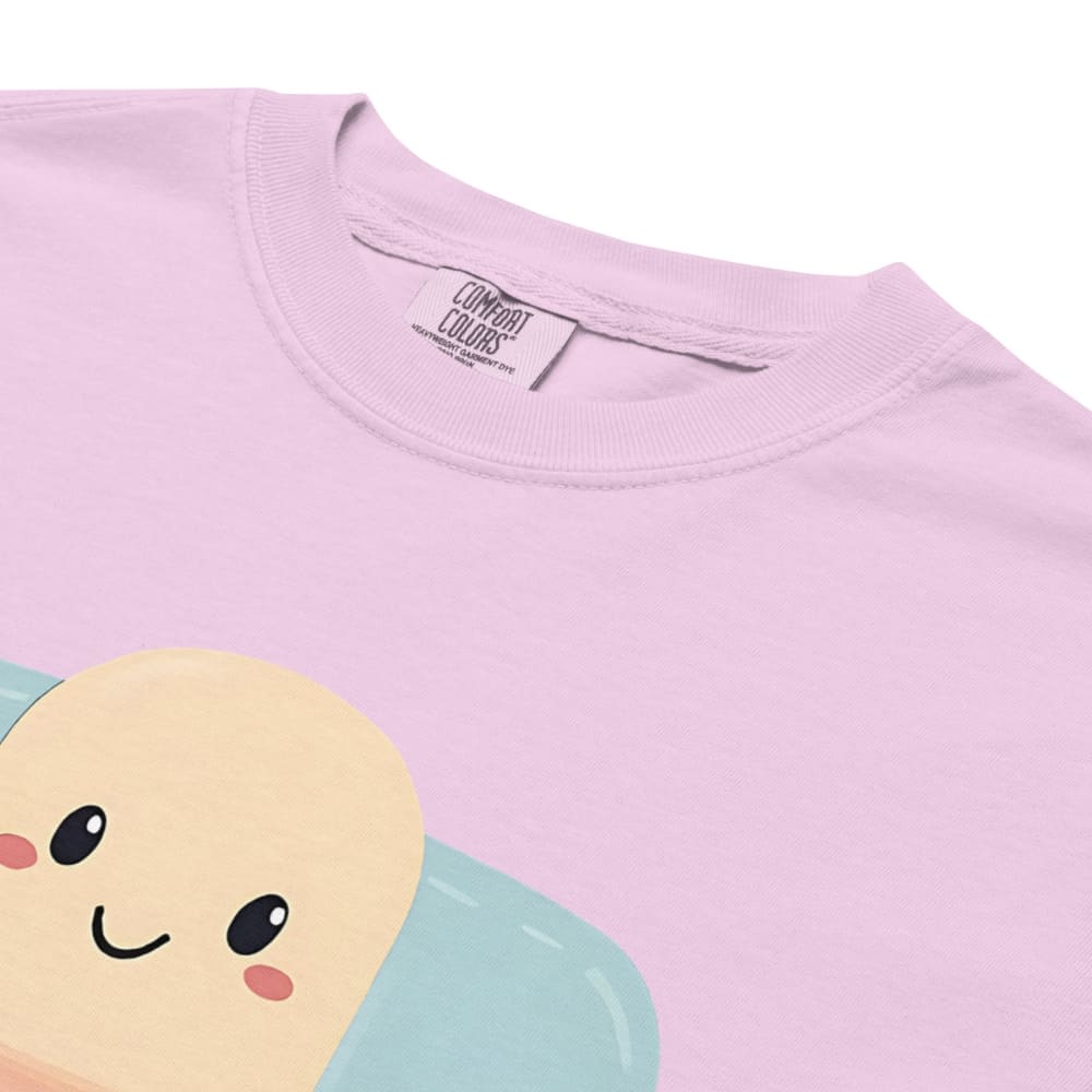 Close-up of a pink t-shirt with a cartoon character design on a white background
