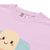 Close-up of a pink t-shirt with a cartoon character design on a white background
