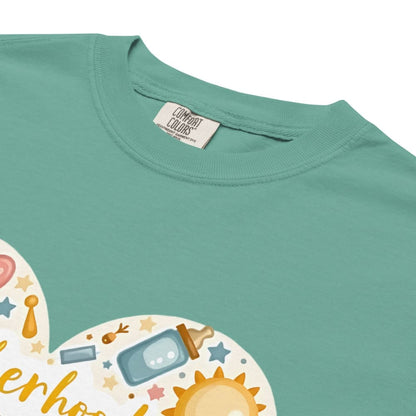 Teal t-shirt with a colorful graphic design and 'Comfort Colors' label.
