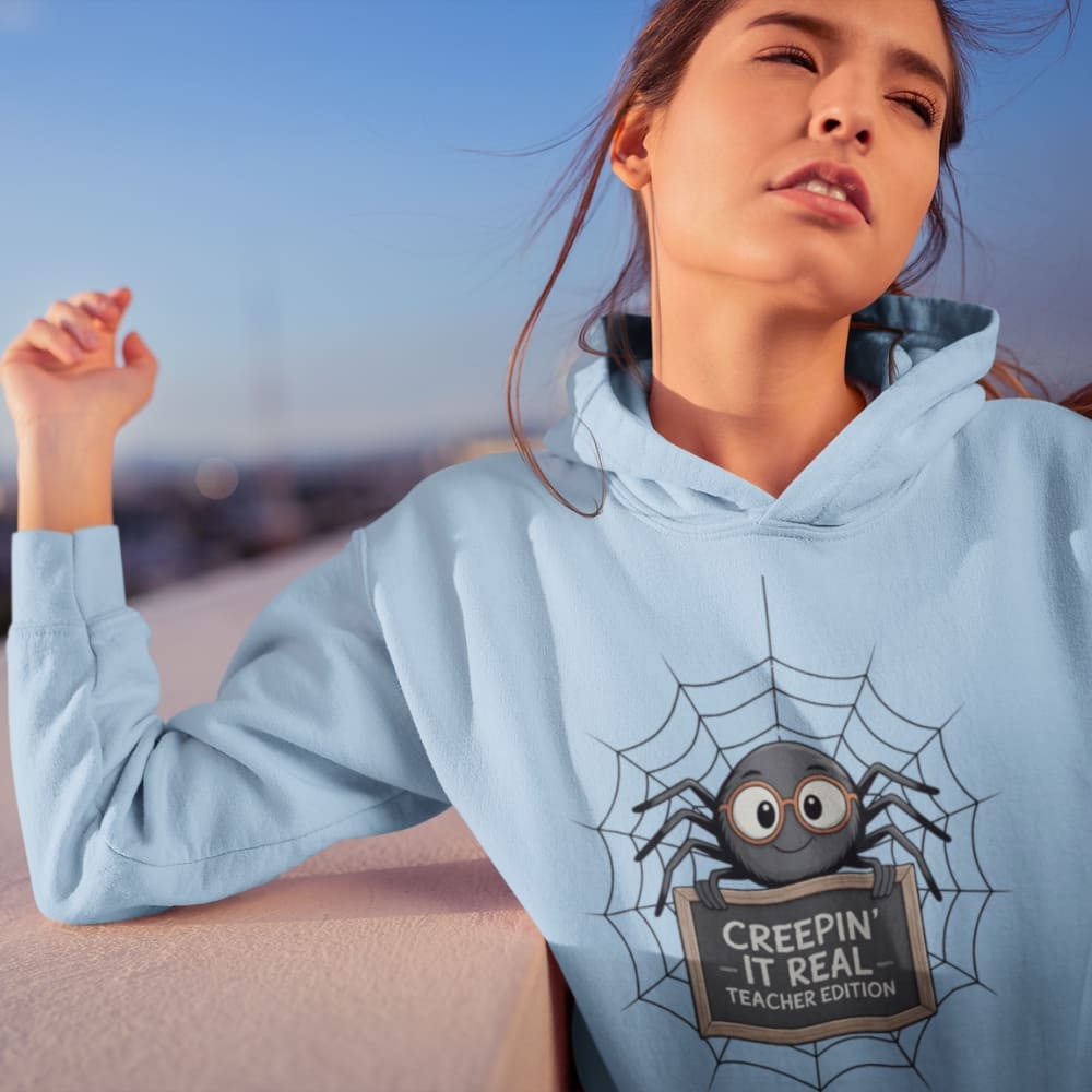 Person wearing a light blue hoodie with a spider graphic and text.
