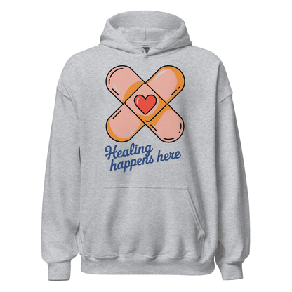 Gray hoodie with bandaid design and 'Healing happens here' text on a white background