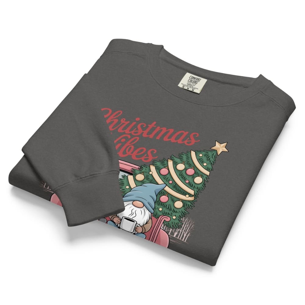 Folded gray sweatshirt with Christmas design and text on a white background