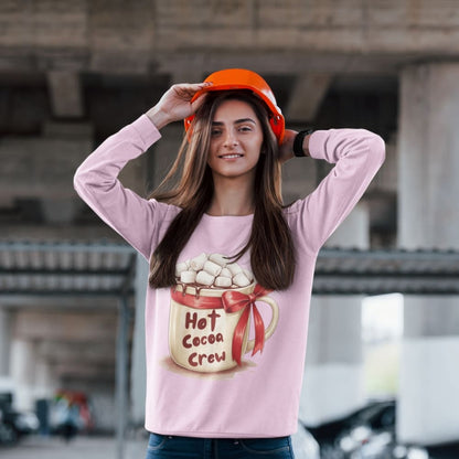 Woman wearing a pink shirt with 'Hot Cocoa Crew' design and an orange hard hat.