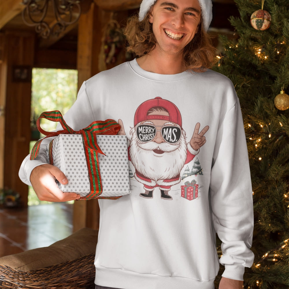 Person wearing a festive sweater with a cartoon character and holding a gift, standing in front of a decorated Christmas tree.