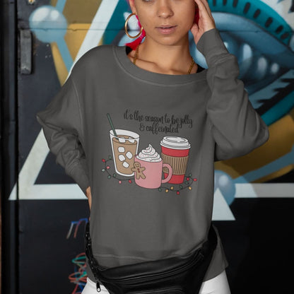 Person wearing a gray sweatshirt with coffee-themed design in front of a colorful mural.