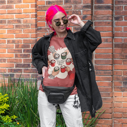 Person wearing a graphic t-shirt, black jacket, and white pants standing against a brick wall.