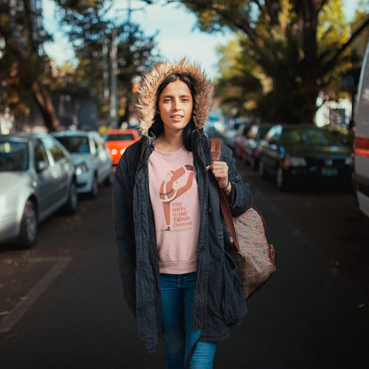 Person wearing a dark coat with a fur-lined hood on a street with cars and trees in the background