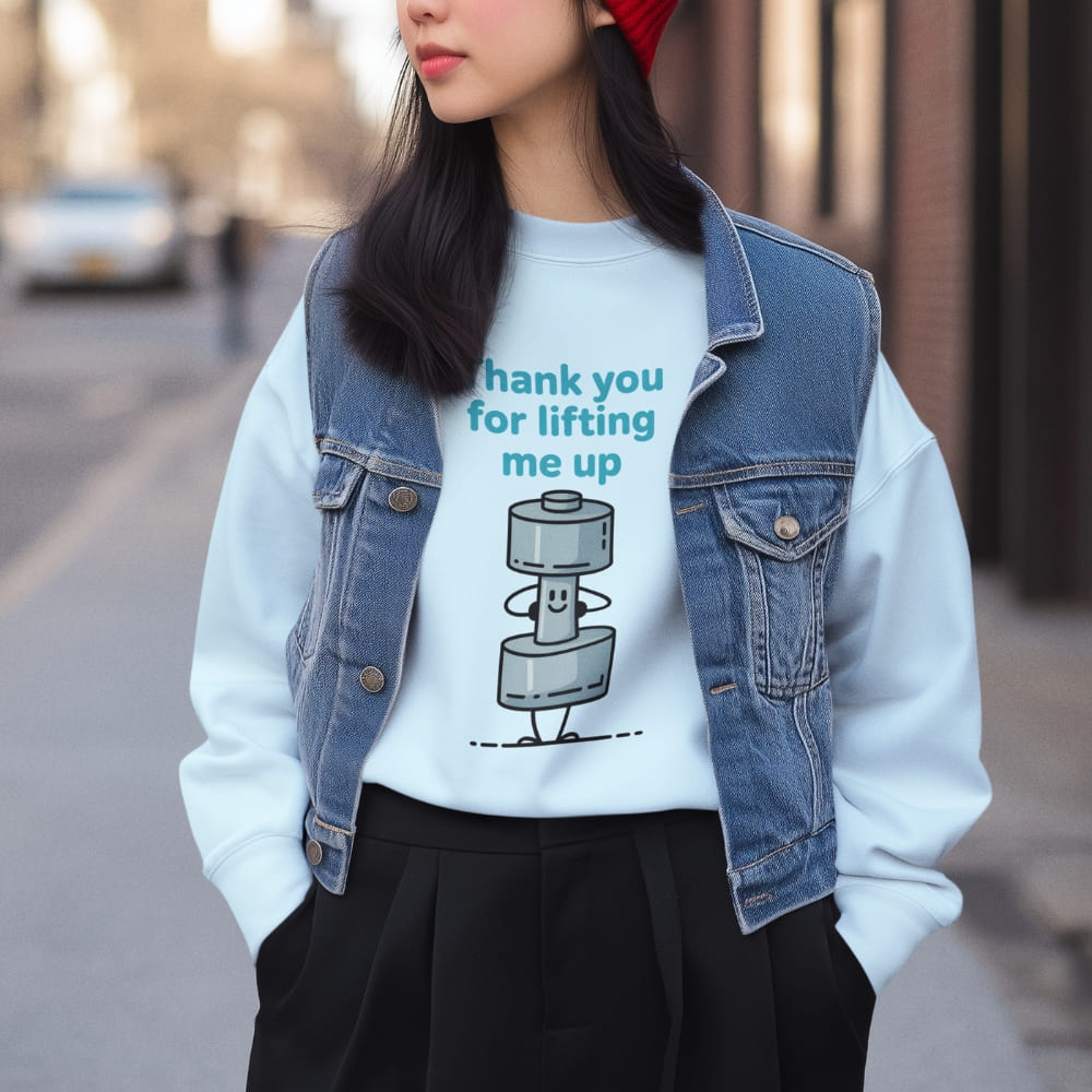 Person wearing a white t-shirt with a robot graphic and text, standing on a street.