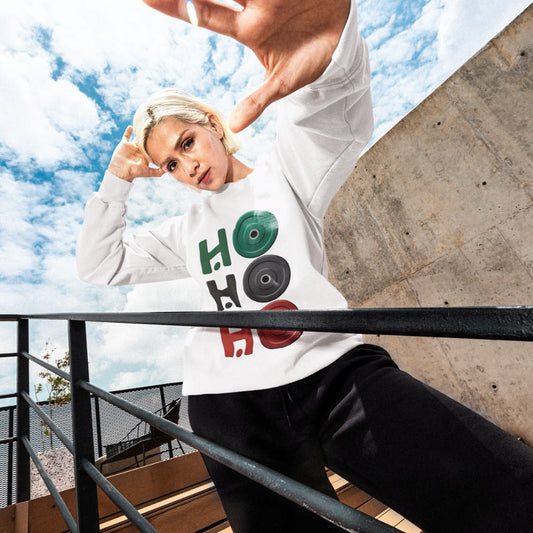Person wearing a white sweatshirt with colorful text outdoors on a sunny day