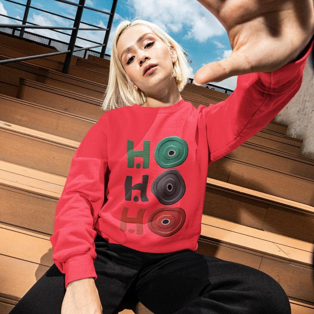 Person wearing a red sweatshirt with 'HO HO HO' design sitting on wooden steps.