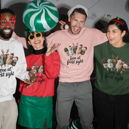 Four people wearing Christmas-themed clothing and accessories, including sweaters and novelty hats.