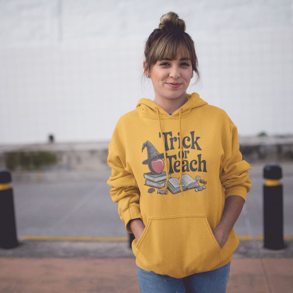 Person wearing a yellow 'Trick or Teach' hoodie with a witch hat graphic.