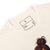 Close-up of a t-shirt label with text and a small illustration on a white background.