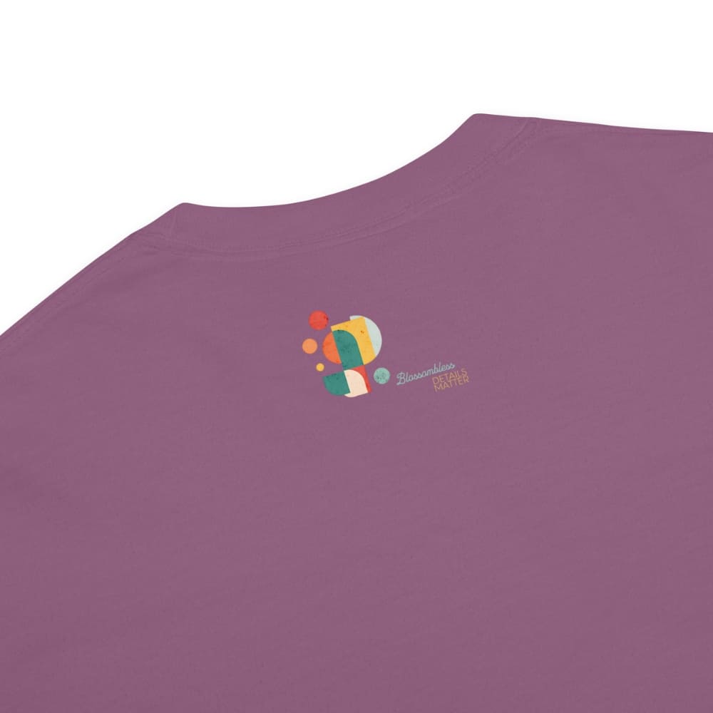 Purple t-shirt with a colorful logo on the chest against a white background