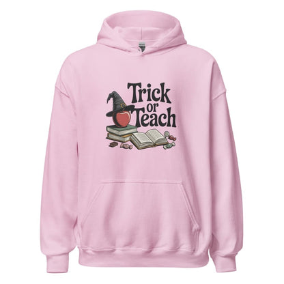 Pink hoodie with 'Trick or Teach' design featuring a witch hat, books, and an apple on a white background.