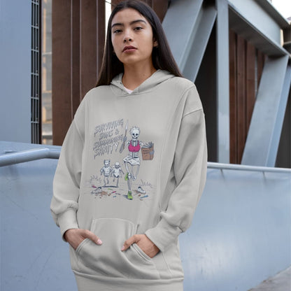 Person wearing a beige hoodie with a graphic design, standing outdoors.