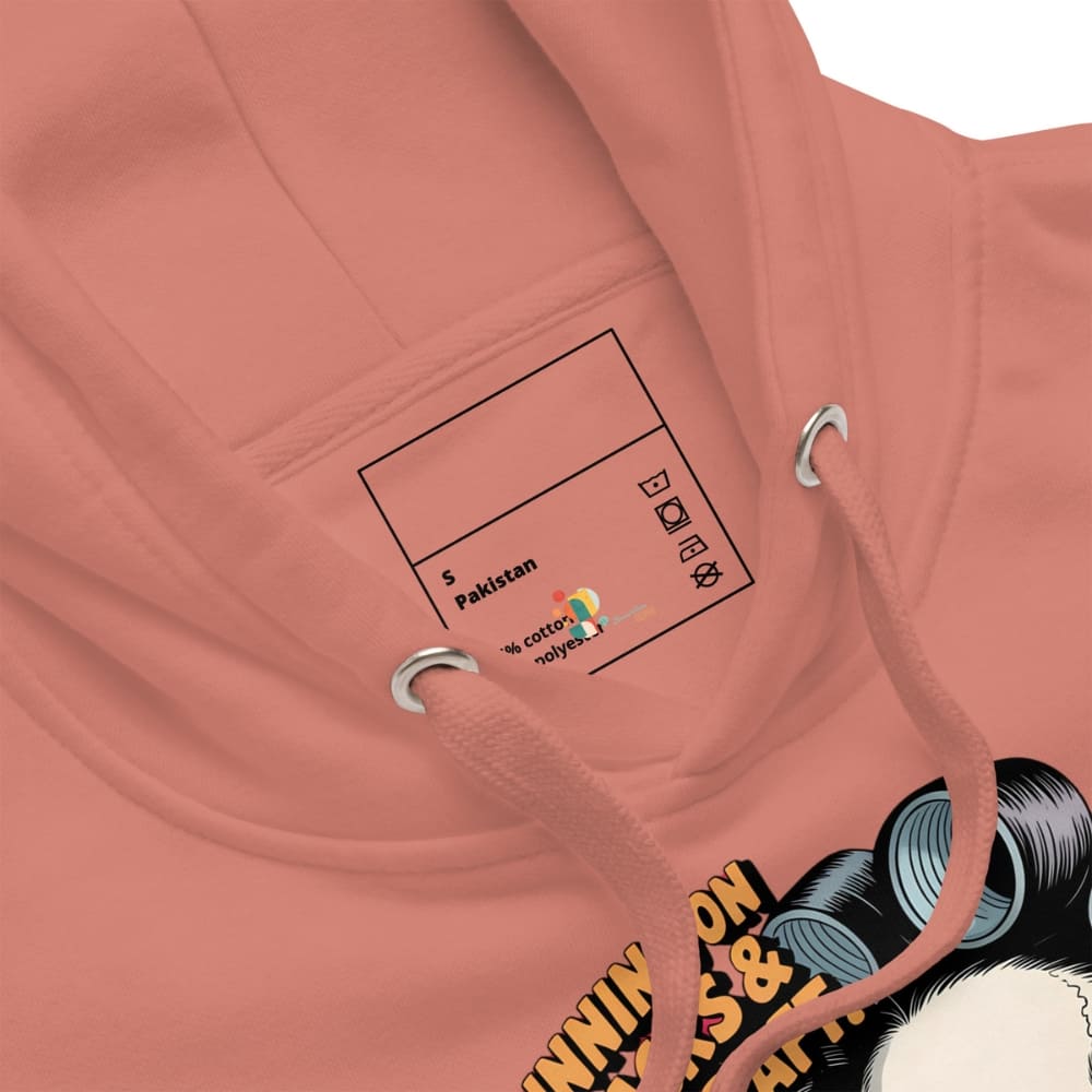 Close-up of a pink hoodie with a label and text on the chest area.