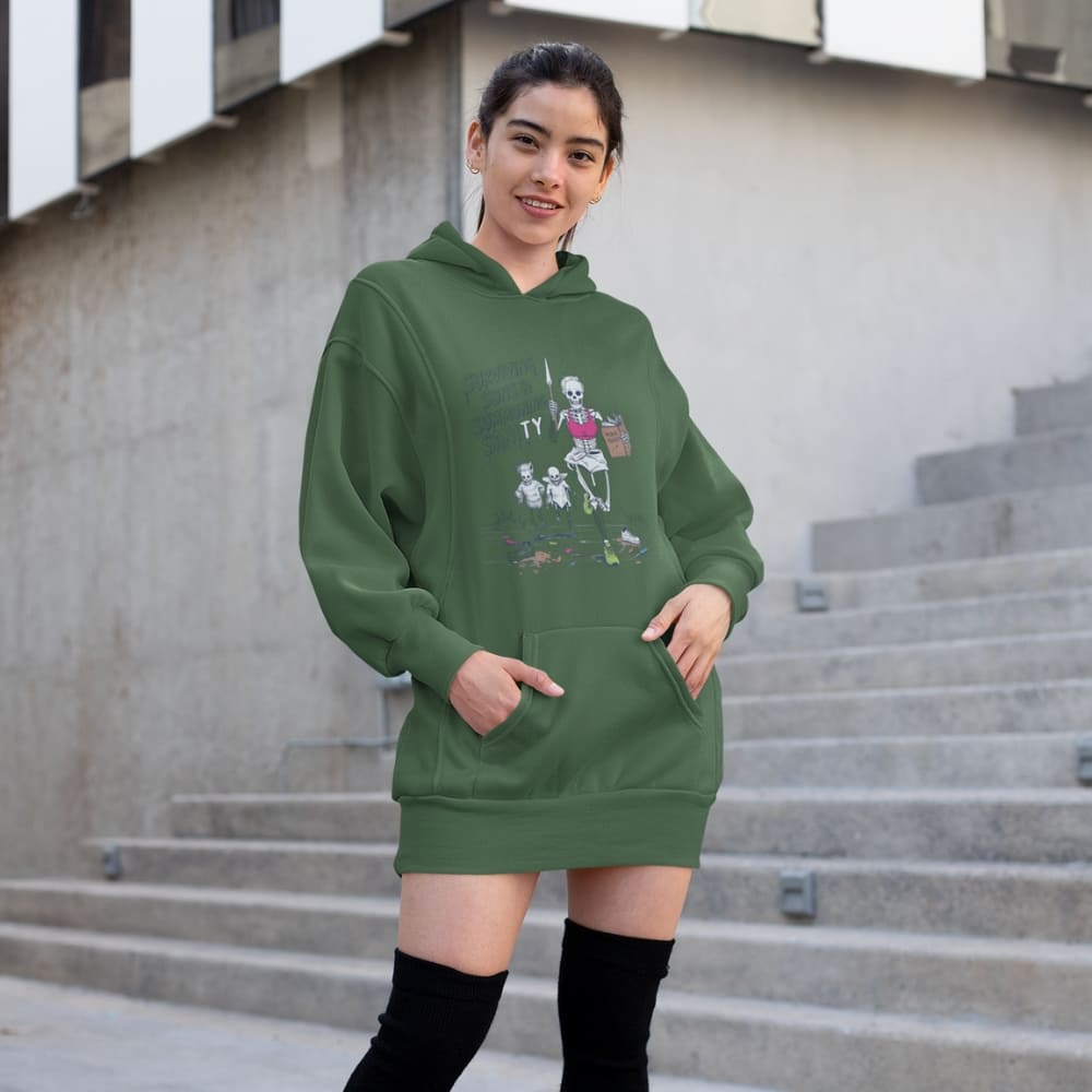 Woman wearing a green hoodie with a graphic design, standing on steps outdoors.