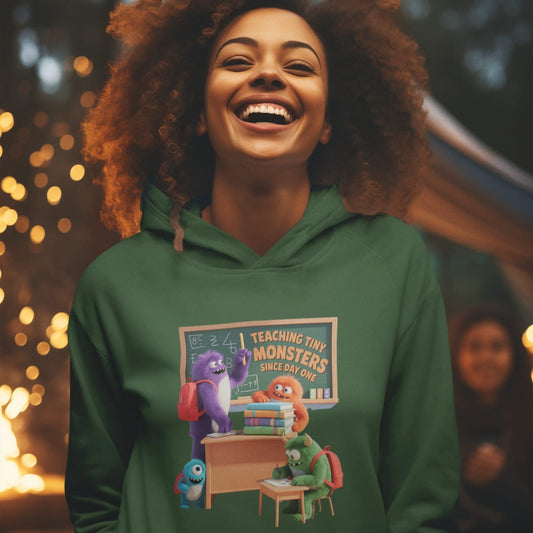 Person wearing a green hoodie with a colorful graphic design in an outdoor setting with lights.