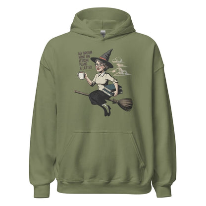 Green hoodie with a graphic of a witch on a broom and text on a white background