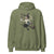 Green hoodie with a graphic of a witch on a broom and text on a white background